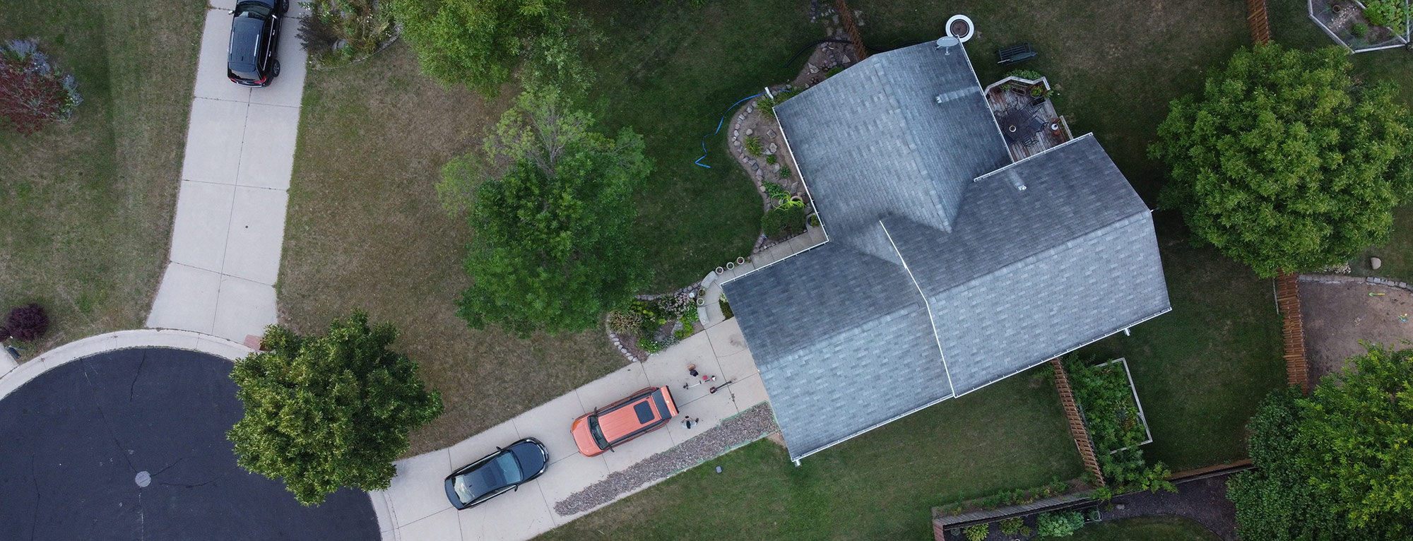Aerial shot of a home being inspected.
